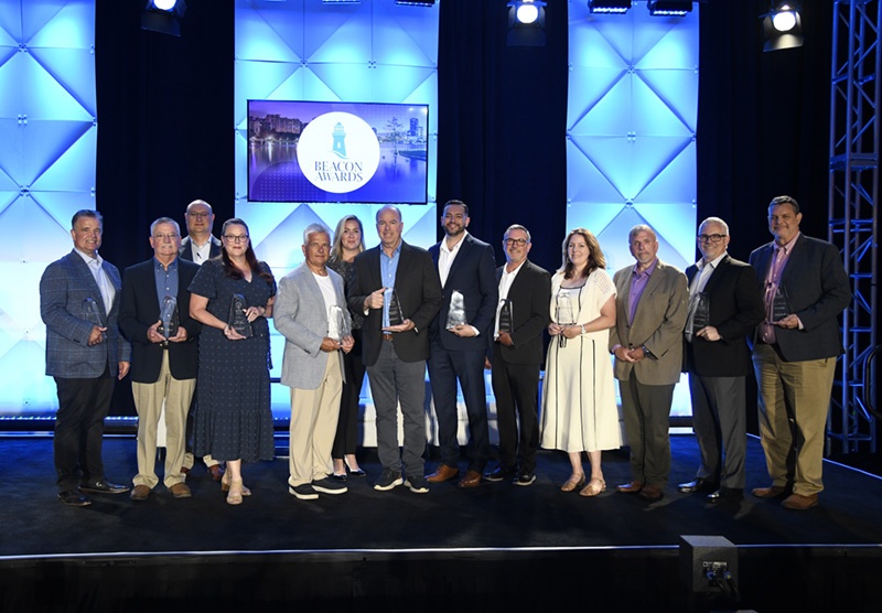 Winners of the 2025 Beacon Awards gather with sponsors.
