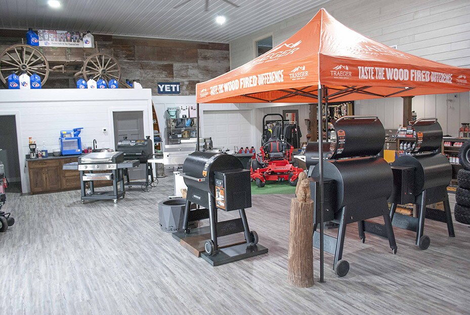 An antique wooden farm wagon is used to display products in the new showroom for outdoor power equipment, grills and rental.